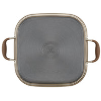 Square gray cooking pot lid with rounded edges, featuring a central embossed logo. Two brown handles are attached on opposite sides. The lid appears to be made of metal and has a shiny, smooth surface.