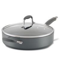 A nonstick saucepan with a glass lid and dual gray handles, one on each side. The pan is a medium size with a matte finish, and the lid has a matching gray handle. The design is modern and functional.
