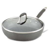 A non-stick gray frying pan with a glass lid, featuring a brushed metal rim and a gray handle. The lid has a matching gray handle with silver accents. The pan has a sleek, modern design.