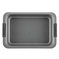 A non-stick rectangular baking pan with handles is shown from above. The surface is smooth and gray, with the brand name Anolon on the handles.