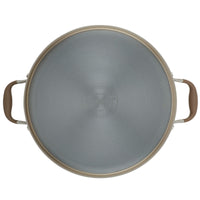 A top view of a metal pan with two brown handles. The pan features the brand name Anolon and details about its construction on the surface. The design is simple and functional.