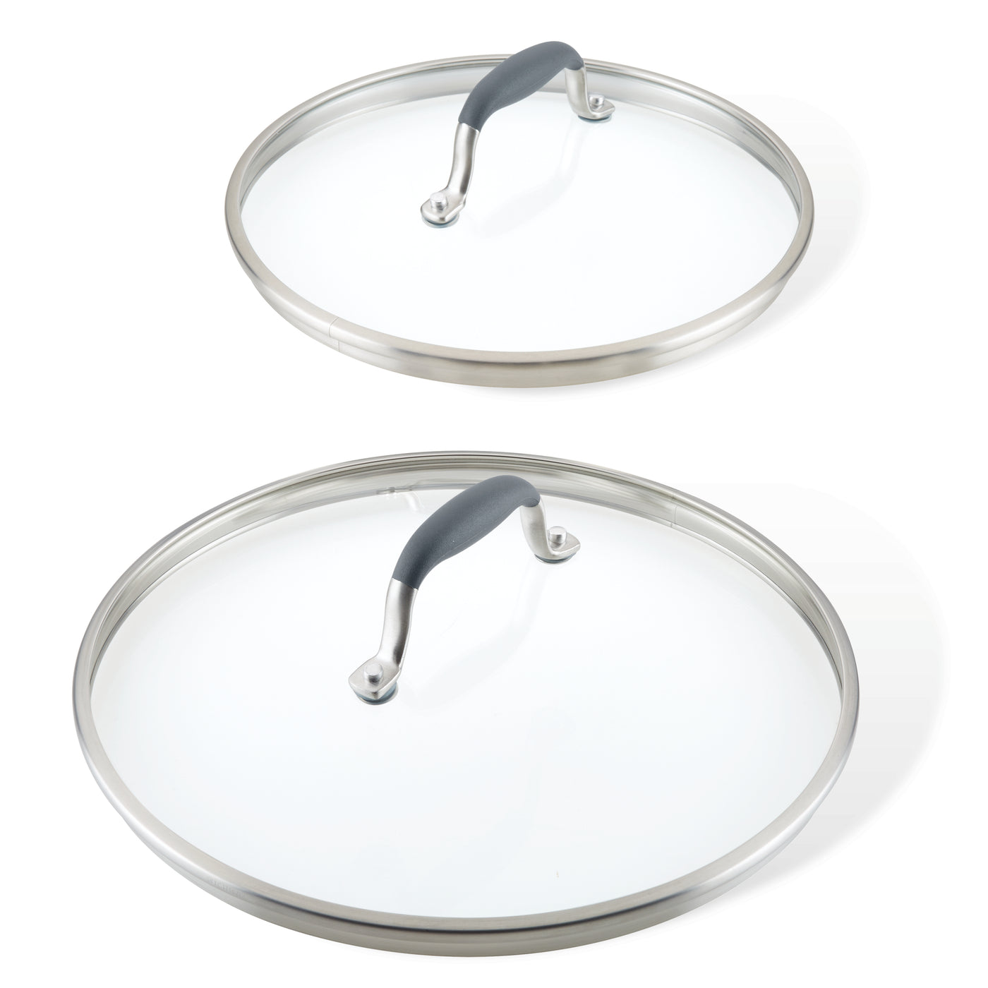 Two glass cookware lids with stainless steel rims and black handles. The lids are of different sizes, one larger and one smaller, placed against a white background.