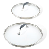 Two glass cookware lids with stainless steel rims and black handles. The lids are of different sizes, one larger and one smaller, placed against a white background.