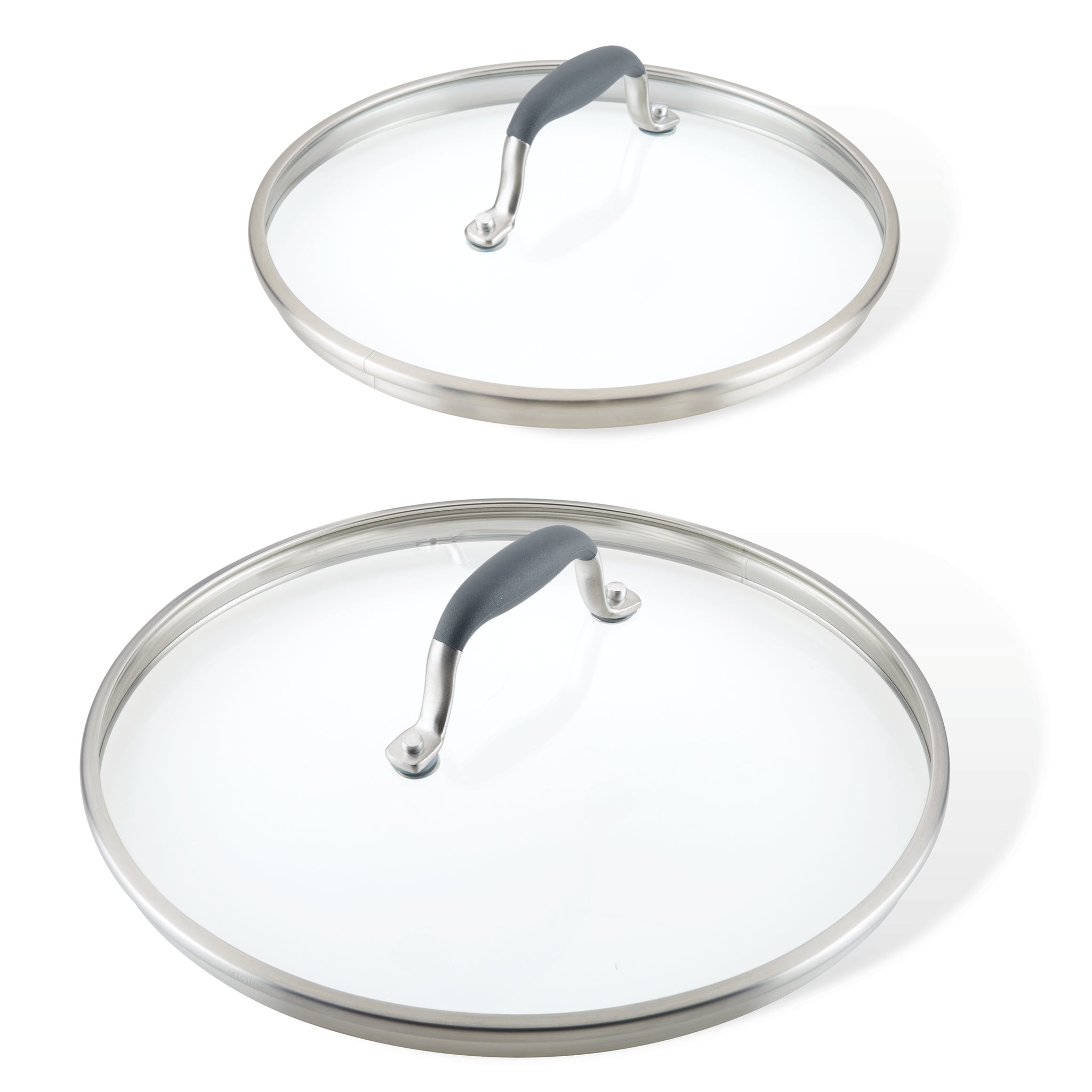 Two glass cookware lids with stainless steel rims and black handles. The lids are of different sizes, one larger and one smaller, placed against a white background.