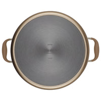 Top view of a round frying pan with a metal surface and two brown handles, one on each side. The pan has a grey, brushed texture and lettering in the center of the base.