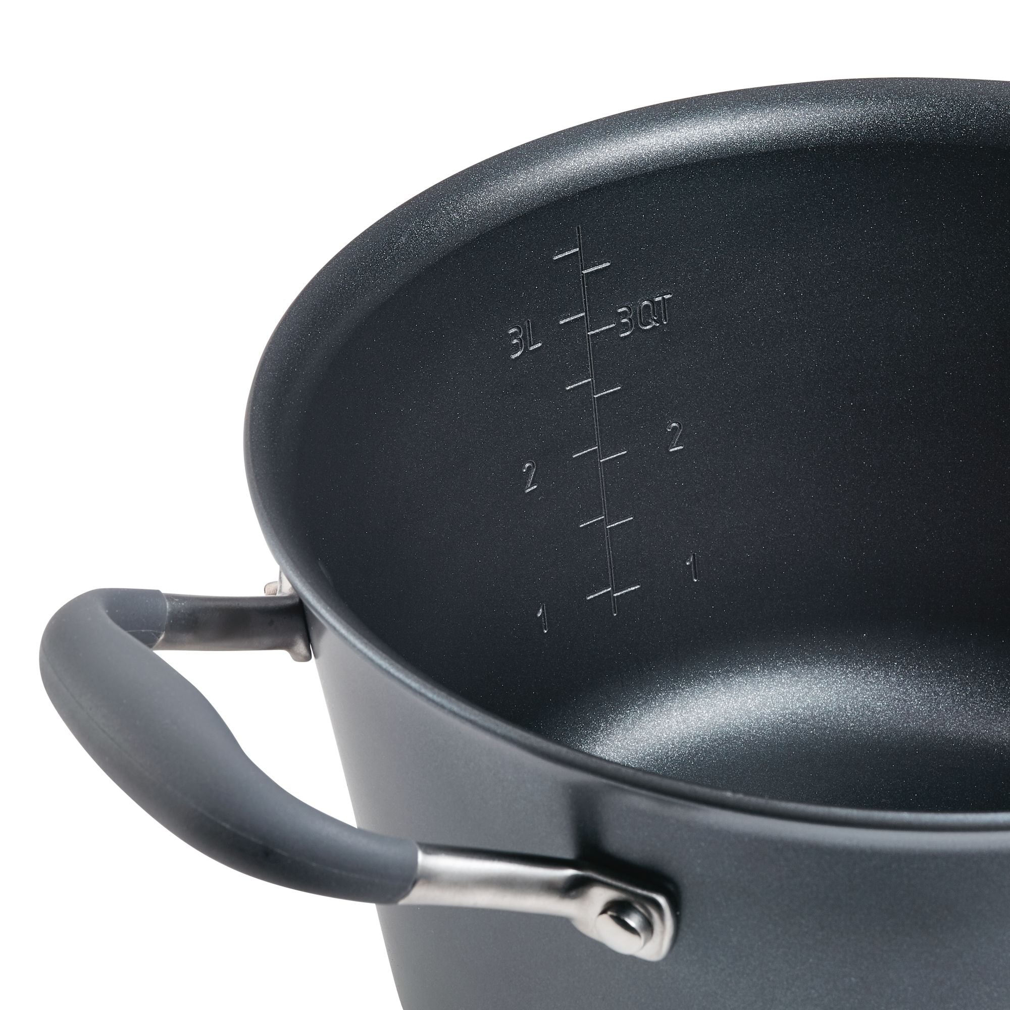 A close-up view of a large black pot with measurement markings inside. The pot has a sturdy handle attached with metal rivets. The surface appears non-stick.