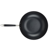 A black non-stick frying pan with a stainless steel handle, shown from above against a white background.