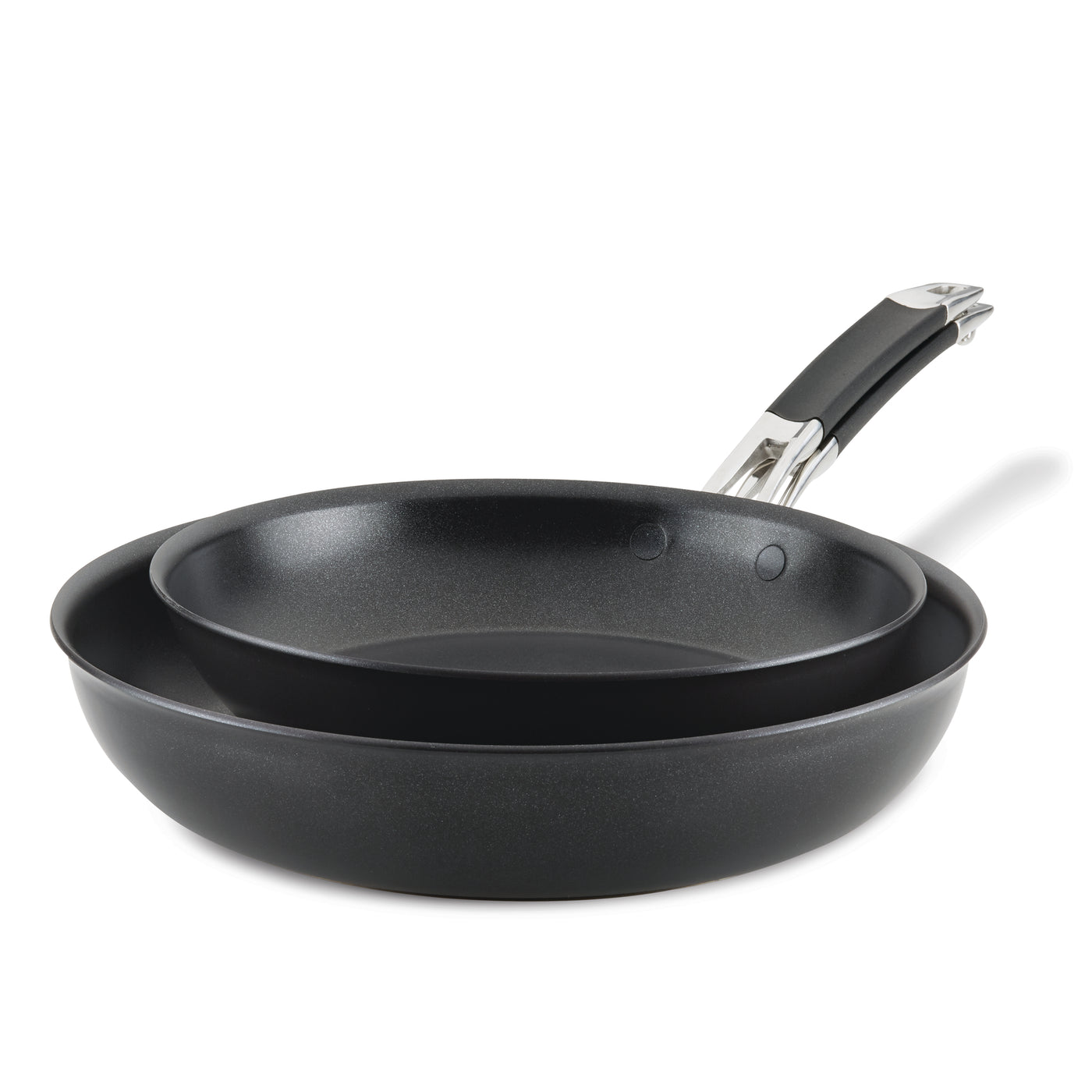 Two non-stick frying pans nested together, one slightly smaller than the other. Both pans have black interiors and exteriors, with shiny metal handles featuring black grips. The pans are positioned against a plain white background.
