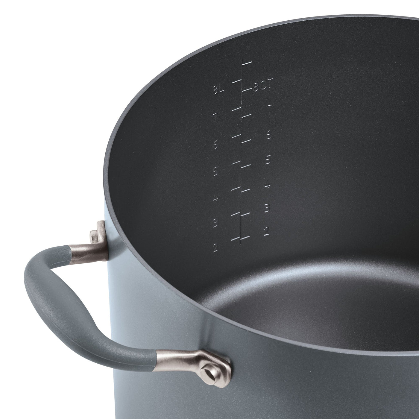A large, empty gray cooking pot with a handle on the side. Inside, there are measurement markings in liters and quarts, embossed on the side. The pot is designed for cooking on a stovetop.
