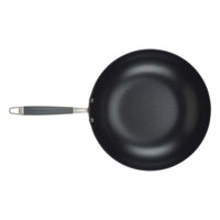 A black frying pan with a non-stick surface and a metal handle featuring a dark grip, viewed from above on a plain white background.