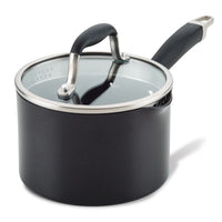 A black saucepan with a glass lid and a black handle. The lid has a stainless steel rim and a handle, while the pan has a spout for pouring. The saucepan is placed on a white background.