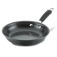 A non-stick black frying pan with a black handle and two metal rivets visible inside. The handle has a stainless steel end with a hole for hanging. The pan is placed on a plain white background.
