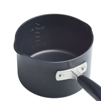 A black saucepan with a curved handle and measurement markings on the inside. It features a pouring spout on one side, and the handle is attached with two metal rivets.