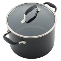 A black pot with a glass lid and stainless steel handles, featuring black grips on the sides and lid. The pot is empty and has a smooth, shiny finish.