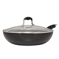 A black, non-stick frying pan with a glass lid and a metal handle, resting on a white background. The pan is slightly deep, suggesting it can be used for both frying and sautéing.