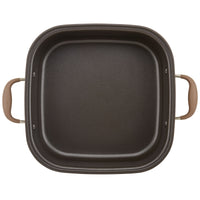 A square, deep black baking dish with two beige handles, viewed from above. The dishs interior has a smooth, non-stick surface.