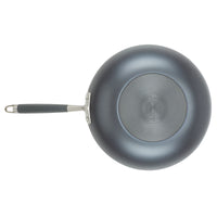 A top-down view of a frying pan with a textured bluish-gray finish. The pan has a circular base and a long handle with a dark grip. The brand logo is embossed on the bottom surface.