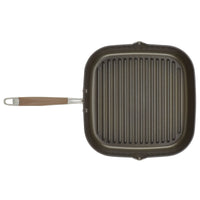 Square grill pan with a non-stick surface and ridged interior, featuring a long handle with a small metal loop at the end. The pan is designed for stovetop cooking and grilling, and is set against a plain white background.