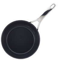 A black non-stick frying pan with a shiny silver handle, viewed from above on a plain white background.