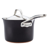 A black saucepan with a shiny stainless steel handle and lid. The brand name Anolon is embossed on the handle. The pot has a sleek, modern design and a copper bottom for improved heat distribution.