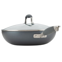A gray, non-stick wok with a glass lid and a silver handle. The wok has a slightly curved shape and the lid features a matching gray handle. The design is modern and sleek.
