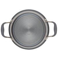 Top view of a round metal pot with two gray handles on either side. The bottom of the pot has engraved text and a brushed stainless steel finish.