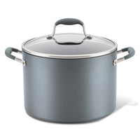 A grey stockpot with a matching lid. The pot has a sleek design with handle grips on either side and a glass lid featuring a metal handle.