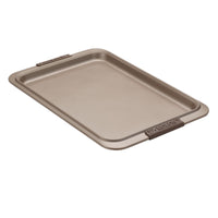 A rectangular nonstick baking sheet with a slightly elevated edge and two grip handles. The surface is smooth and metallic, designed for baking and roasting.