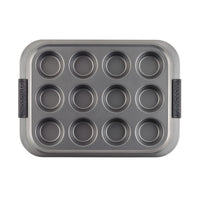 A rectangular muffin pan with 12 circular molds, featuring two black handles on the sides. The pan is made of non-stick metal.
