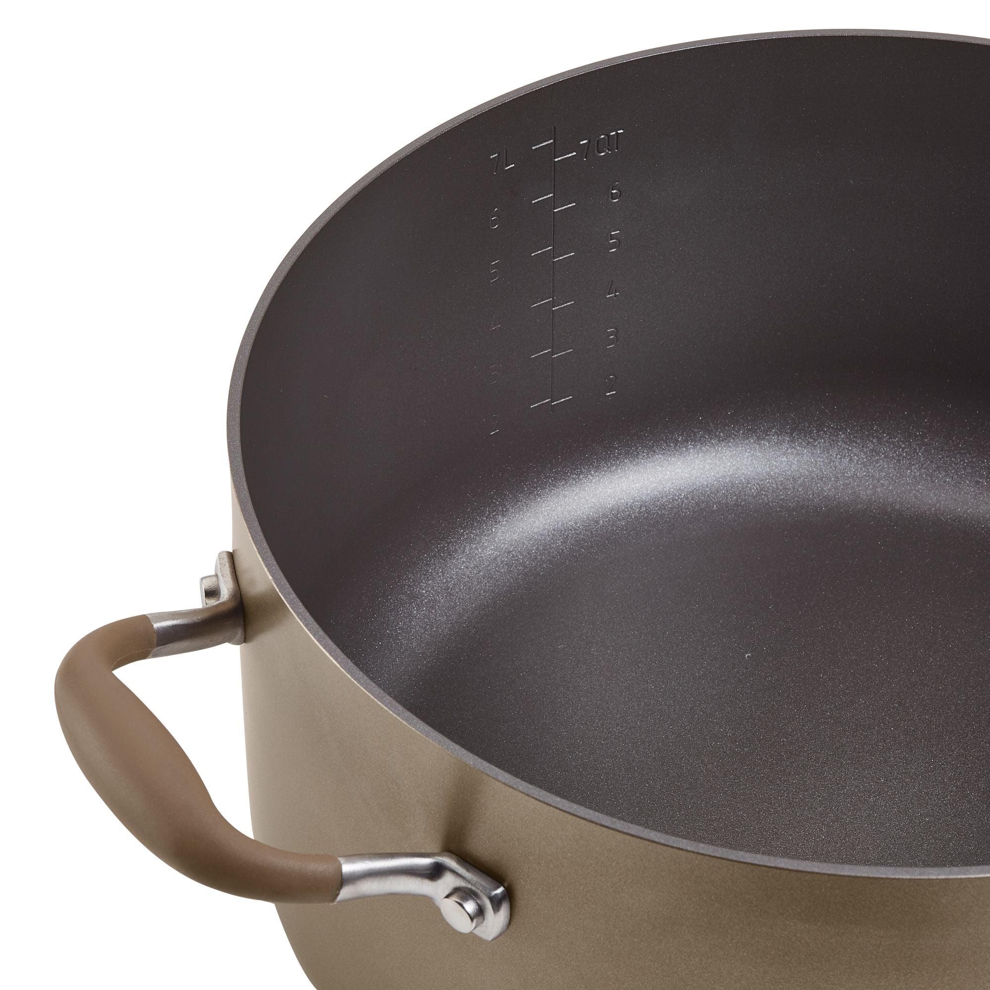 A close-up of a large cooking pot with a non-stick interior and measurement markings on the inside. It has sturdy metal handles with brown grips on both sides. The pot is empty and sits on a white surface.