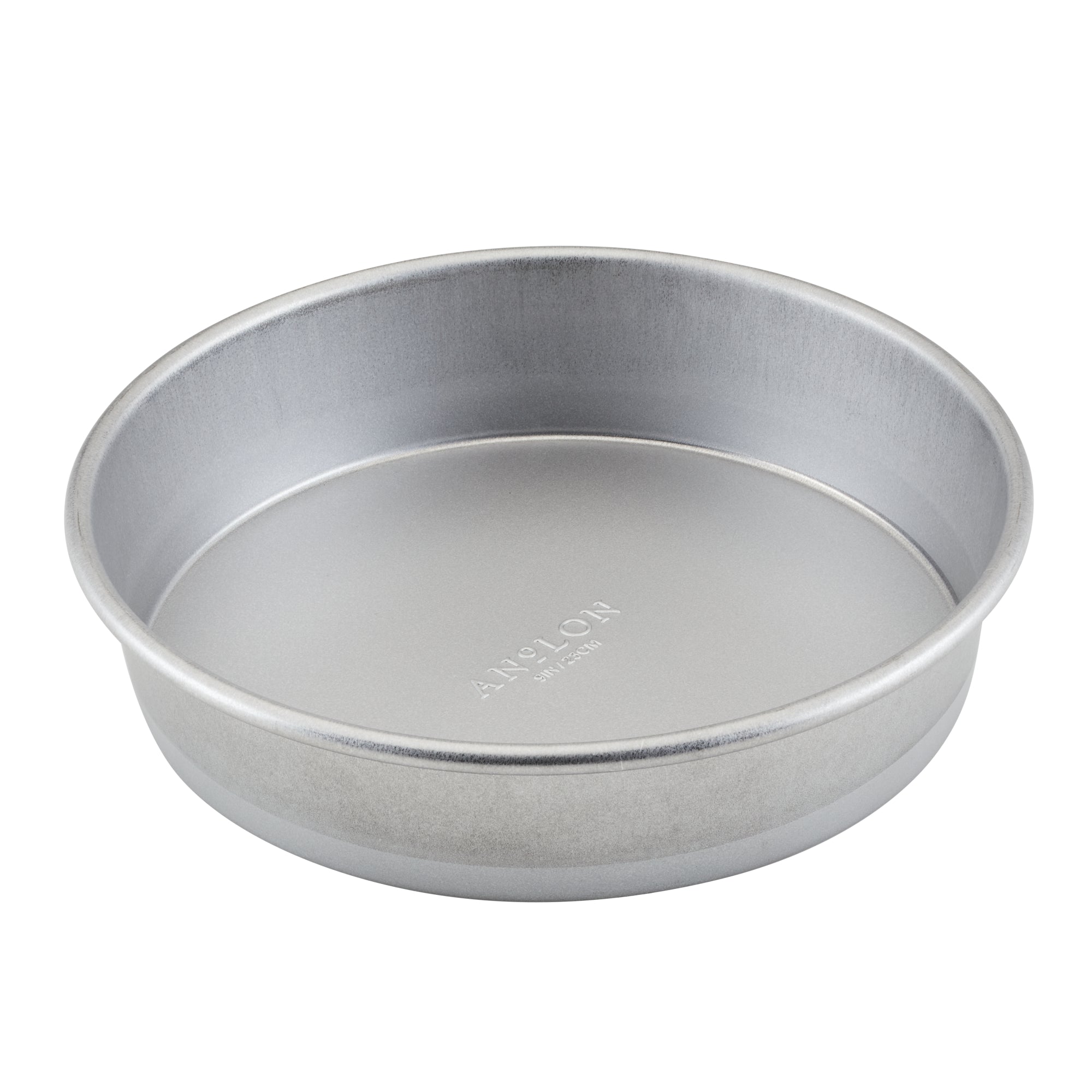 The Pro-Bake 9-Inch Aluminized Steel Round Cake Pan, with its smooth interior surface and silver finish, is ideal for creating layered desserts.