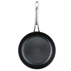 A top-down view of an Anolon X frying pan from the 8-Piece Hybrid Nonstick Cookware Set shows its grid-patterned interior enhanced by SearTech technology. The stainless steel handle has a hole for hanging. The innovative pan appears isolated on a white background.