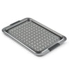 The Advanced 10 x 15-Inch Crisper Pan Set features a nonstick metal roasting pan with a removable crisper insert, black silicone handles labeled "ANOLON," and raised edges for convenience and safety.