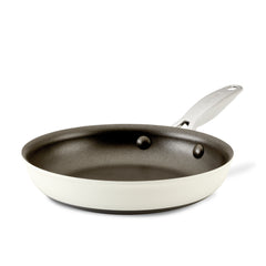 The Achieve 8.25-Inch Hard Anodized Nonstick Frying Pan boasts a black interior and a white exterior, complemented by a stainless steel handle. This easy-to-clean frying pan is elegantly displayed against a plain white background.