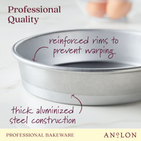 A close-up of the 9-Inch Aluminized Steel Round Cake Pan from Pro-Bake showcases features such as reinforced rims to prevent warping and thick aluminized steel construction. In the background, blurred eggs in a bowl can be seen. Text: Professional Quality and Professional Bakeware Pro-Bake—ideal for baking perfect layers.