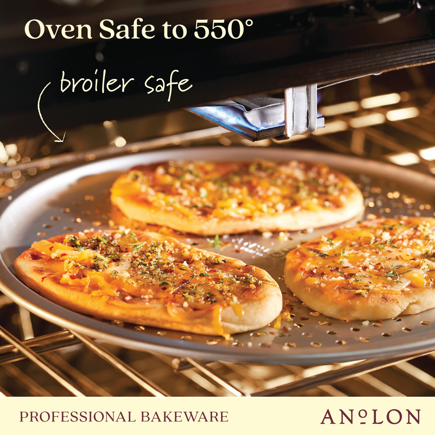 Three thin crust pizzas loaded with cheese, herbs, and toppings are baking on a 14-Inch Aluminized Steel Perforated Pizza Pan inside an oven. The text on the image states that it is oven safe up to 550° and broiler safe. The Pro-Bake brand logo is featured alongside the term Professional Bakeware.