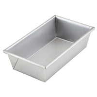 The 9-Inch x 5-Inch Aluminized Steel Loaf Pan by Pro-Bake features uncoated aluminized steel construction with straight sides and a flat base, making it ideal for baking bread. Known for its exceptional heat conduction, this loaf pan has a smooth, matte finish and is oven safe up to 550°F. It is elegantly presented empty against a plain white background.