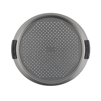 The 13-Inch Pizza Crisper by Advanced features a round, perforated metal design for even baking. It includes a nonstick surface and two black rubber handles on opposite sides for easy handling. This crisper is oven safe, making it an ideal choice for perfectly baked pizzas.