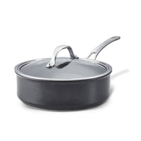 The 3.5-Quart Hybrid Nonstick Induction Sauté Pan with Lid by Anolon X, featuring SearTech technology, includes a shiny metal handle and transparent lid. Oven safe to 500°F and induction-ready, it blends style with advanced functionality for all kitchen needs against a plain white background.