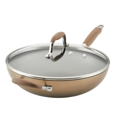 Introducing the 12-Inch Hard Anodized Nonstick Ultimate Pan with Lid by Advanced Home: This brown skillet features two handles, a glass lid with a silver rim and brown grip. Its sleek, modern design includes an innovative 4-hinge locking system on the lid, providing versatile and secure cooking for every culinary adventure.