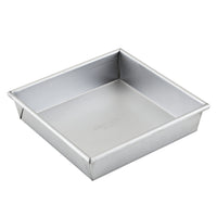 The Pro-Bake 9-Inch Aluminized Steel Square Cake Pan features smooth, slightly raised edges and straight sides for even baking. Its plain, reflective interior ensures durable heat conduction, making it perfect for cakes or other dishes.