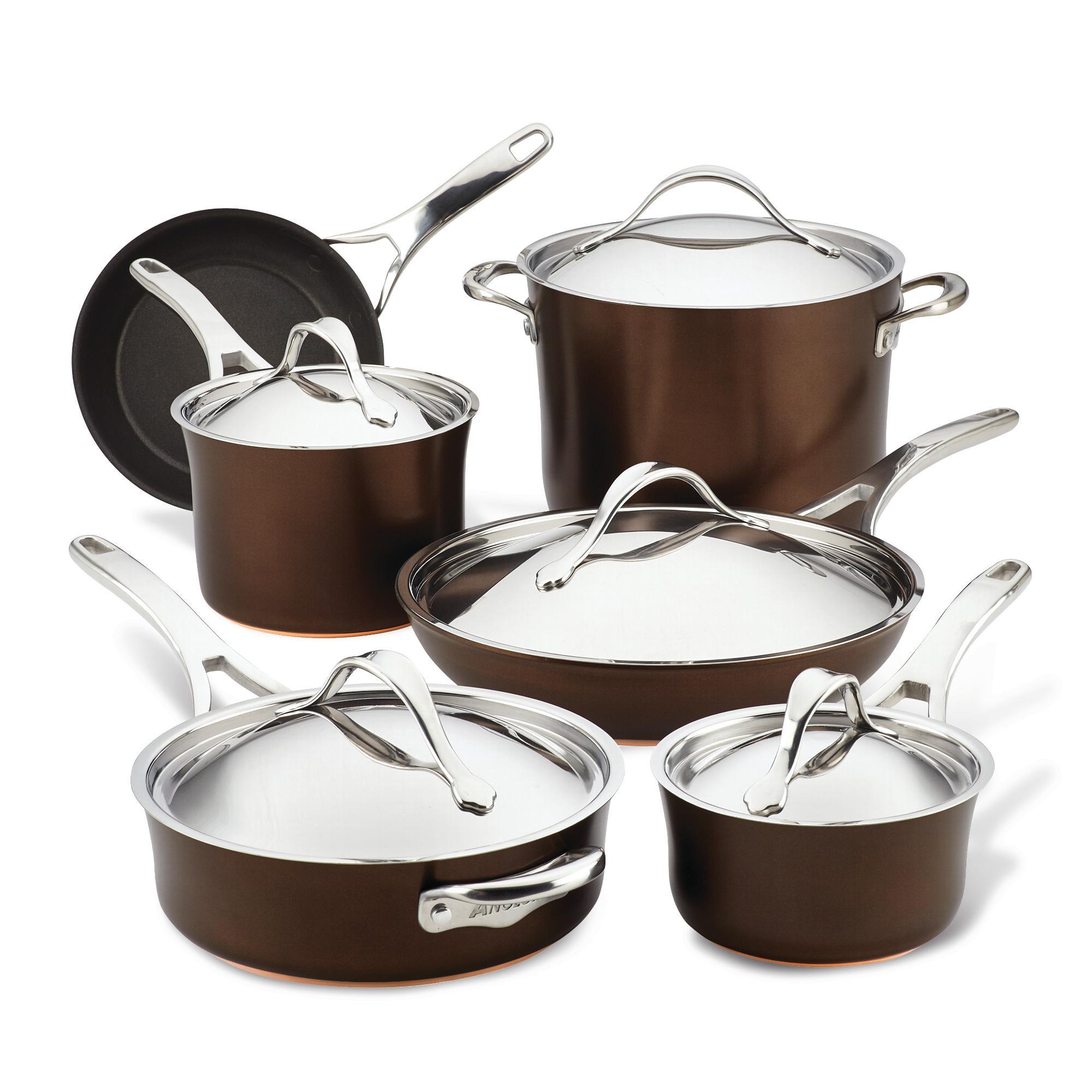 The Nouvelle Luxe 11-Piece Cookware Set features a collection of dark brown nonstick cookware with silver handles, comprising three saucepans with lids, a stockpot with lid, a skillet, and a sauté pan with lid, all neatly arranged.