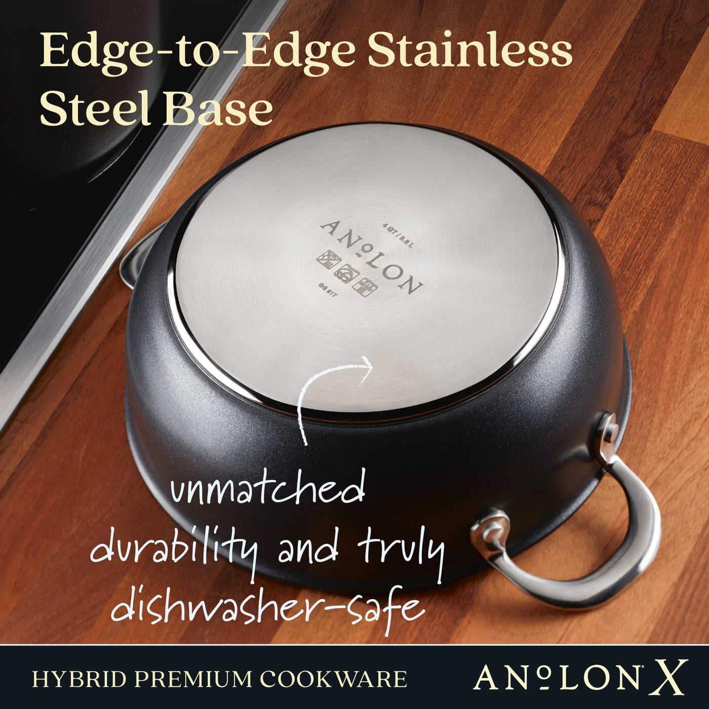An Anolon X 4-Quart Hybrid Nonstick Casserole Pan with an edge-to-edge stainless steel base is upside down on a wooden surface, featuring dual handles and branded markings. It highlights an ultra-durable nonstick finish and is truly dishwasher-safe.
