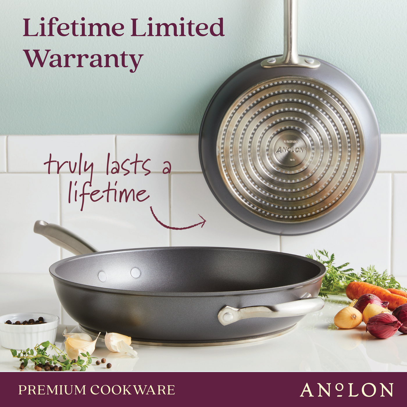 Two Accolade 10 & 12-Inch Frying Pans are shown in a kitchen, one flat with vegetables nearby and one hanging to display its precision forged base. Text reads Lifetime Limited Warranty—truly lasts a lifetime.