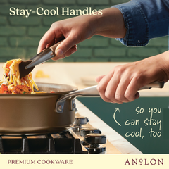 A person uses silver tongs to lift pasta from a hard-anodized aluminum saucepan on a stove. The pan features stay-cool handles. Text reads, "Stay-Cool Handles so you can stay cool, too." Brand: Ascend.