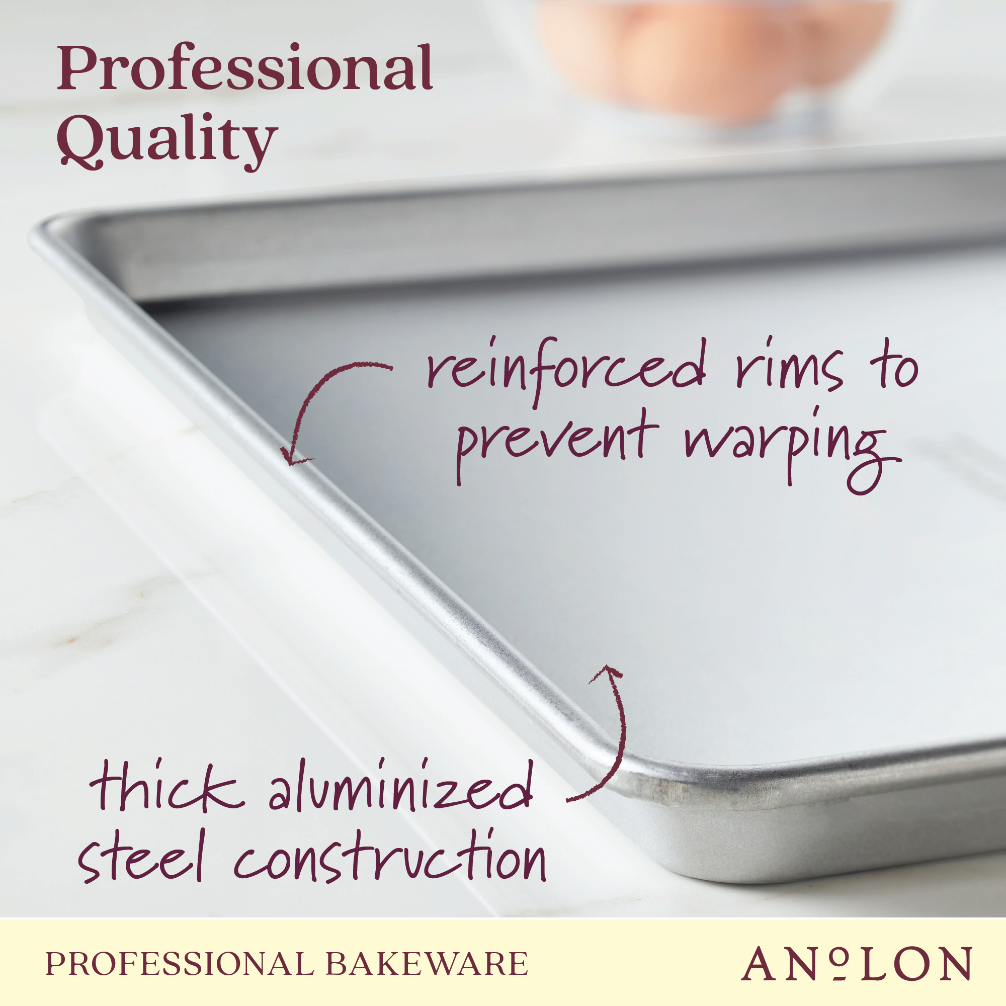 The Pro-Bake 2-Piece Aluminized Steel Half Sheet Pan Set is showcased on a white surface, emphasizing its features such as reinforced rims to prevent warping and sturdy aluminized steel construction. In the background, blurred eggs symbolize its status as top-tier professional bakeware.
