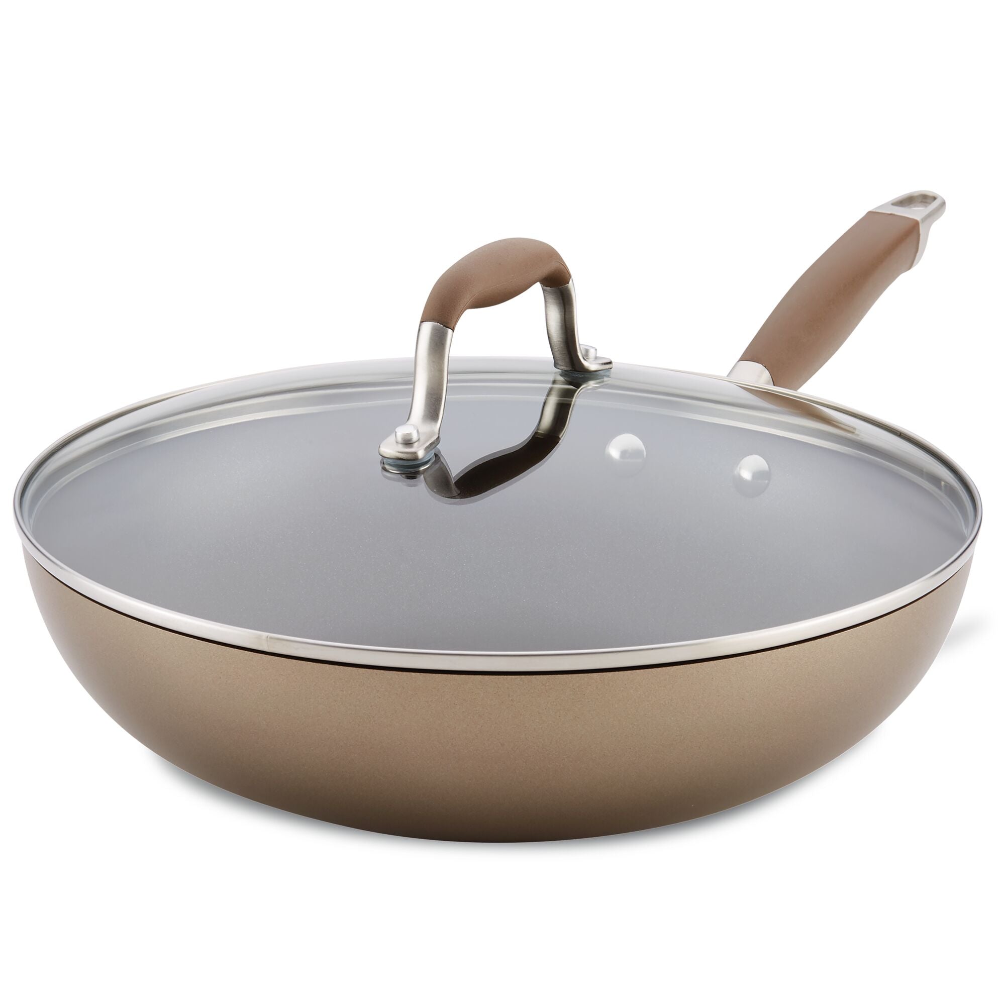 The 12-Inch Ultimate Stir Fry Pan by Advanced Home boasts a hard-anodized, metallic bronze exterior and a sleek, dark interior. This pan includes a glass lid and comes with a matching brown handle, all elegantly balanced at an angle.