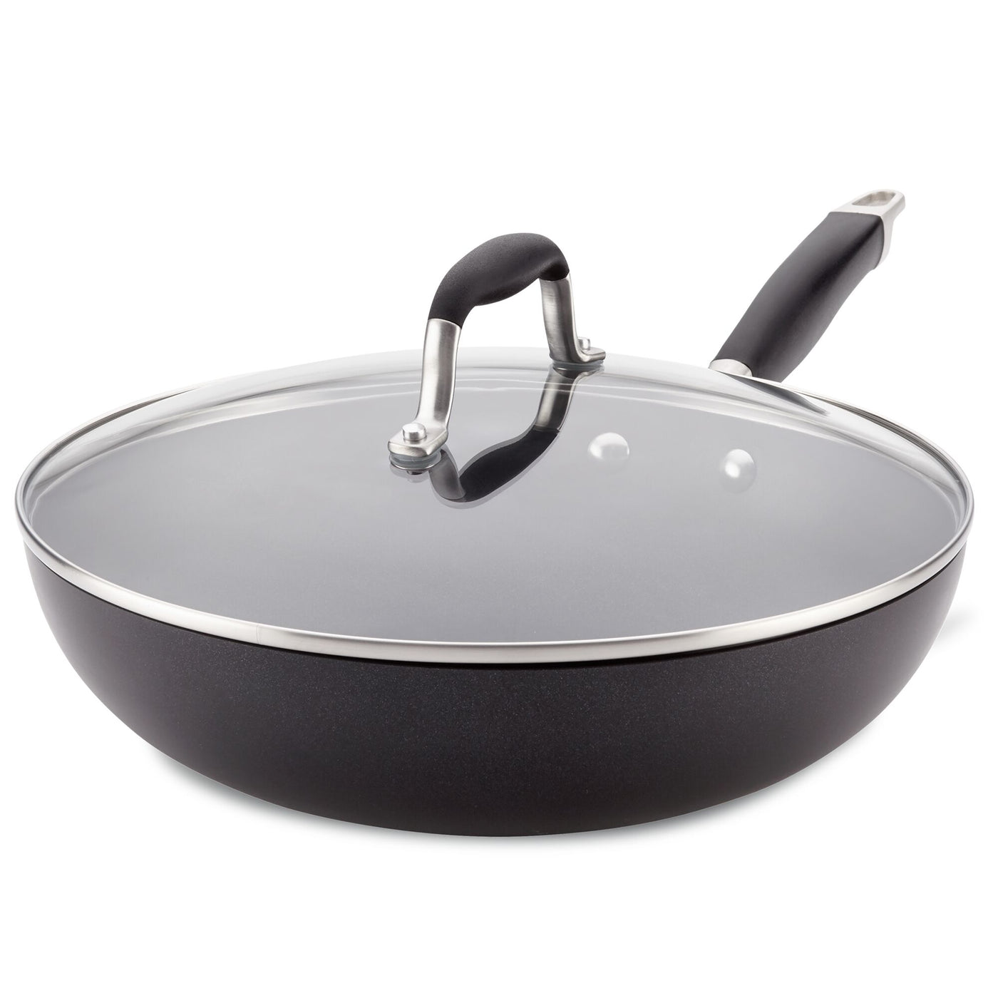 The Advanced Home 12-Inch Ultimate Stir Fry Pan features a sleek design with a shiny metal rim around its glass lid and hard-anodized construction. Its spacious, black surface is complemented by a raised arch handle for easy gripping, making it the ultimate pan for kitchen enthusiasts.