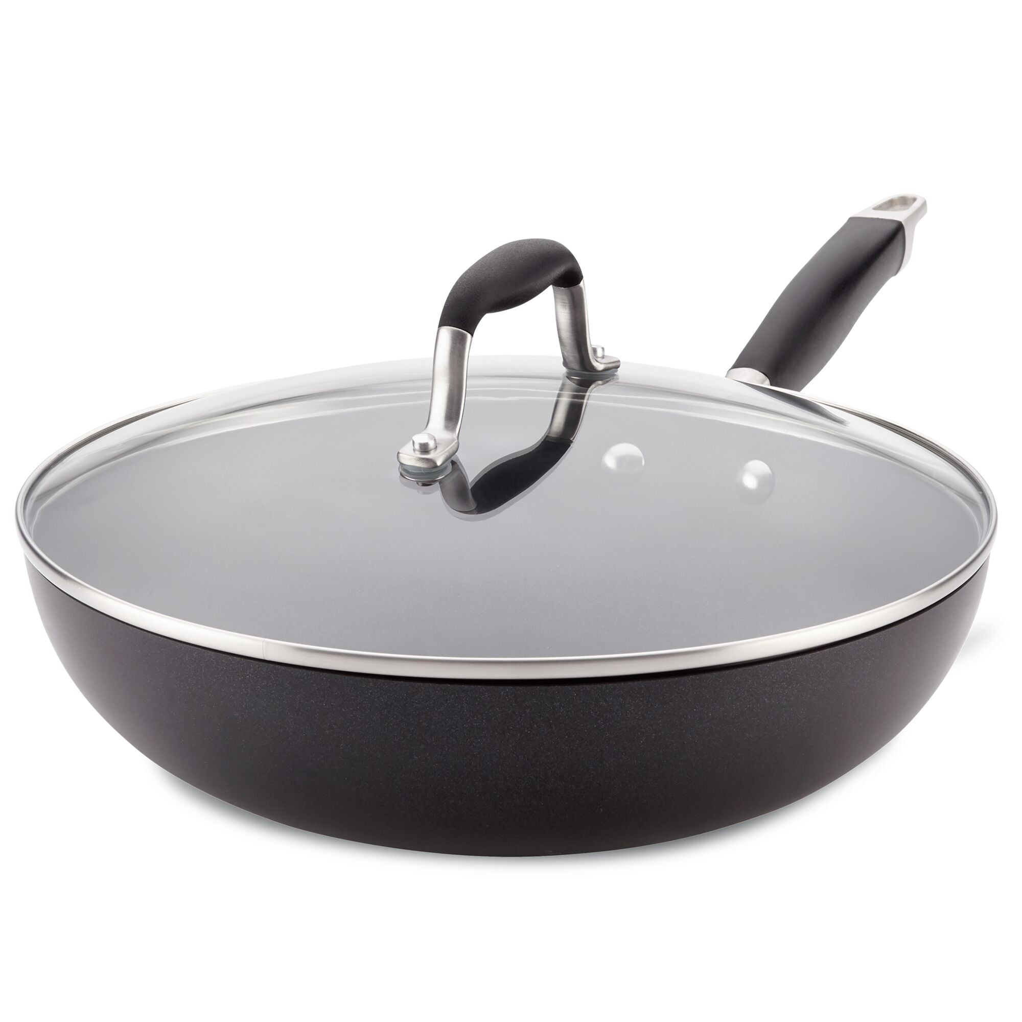 The Advanced Home 12-Inch Ultimate Stir Fry Pan features a sleek design with a shiny metal rim around its glass lid and hard-anodized construction. Its spacious, black surface is complemented by a raised arch handle for easy gripping, making it the ultimate pan for kitchen enthusiasts.