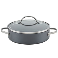 The Advanced Home 3-Piece Nonstick Cookware Set includes a gray hard anodized pot with a glass lid and metal handles. Resembling a sauté pan, this pot features a wide, flat base and riveted handles for sturdy grips. The lid is equipped with a metal loop handle at the top, ensuring ease of use and optimal heat distribution.